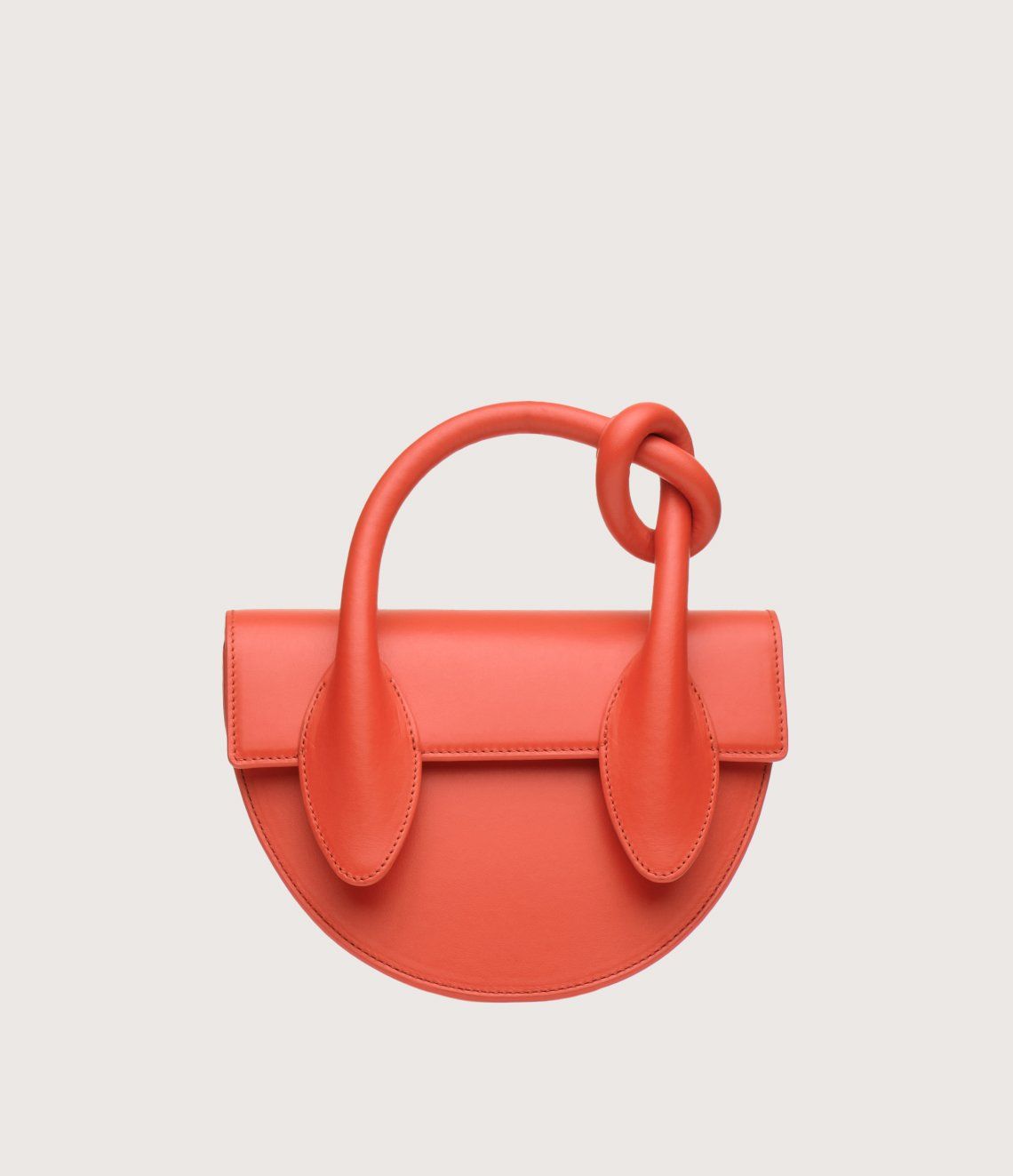 A red purse with a knot in the handle