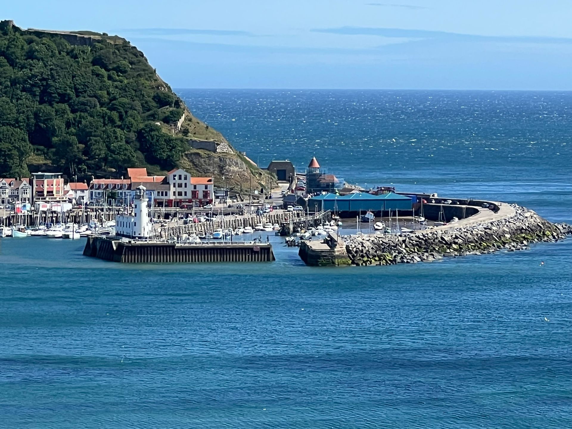 Scarborough Harbour with fishing boats and yachts, overlooked by the lighthouse.