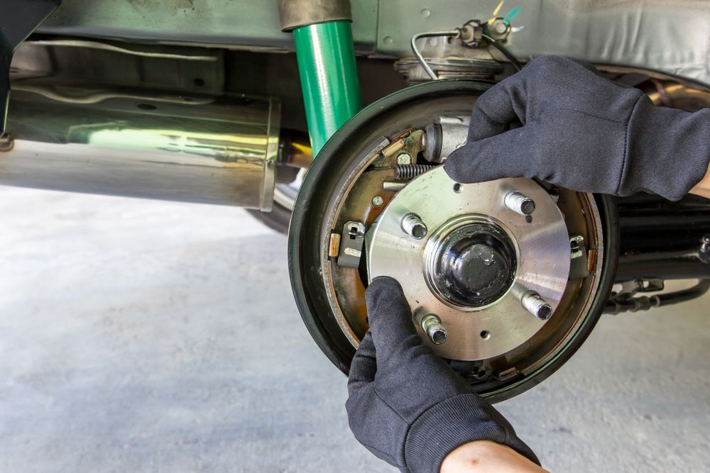 A Person Is Changing the Brake Pads on A Car — Steve Purse Automotive In Woollamia, NSW
