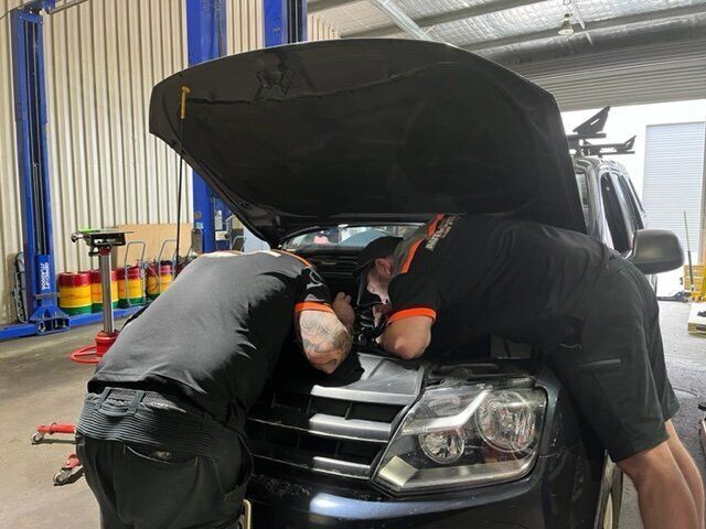 Two Men Are Working on A Car in A Garage with The Hood Open — Steve Purse Automotive In Huskisson, NSW
