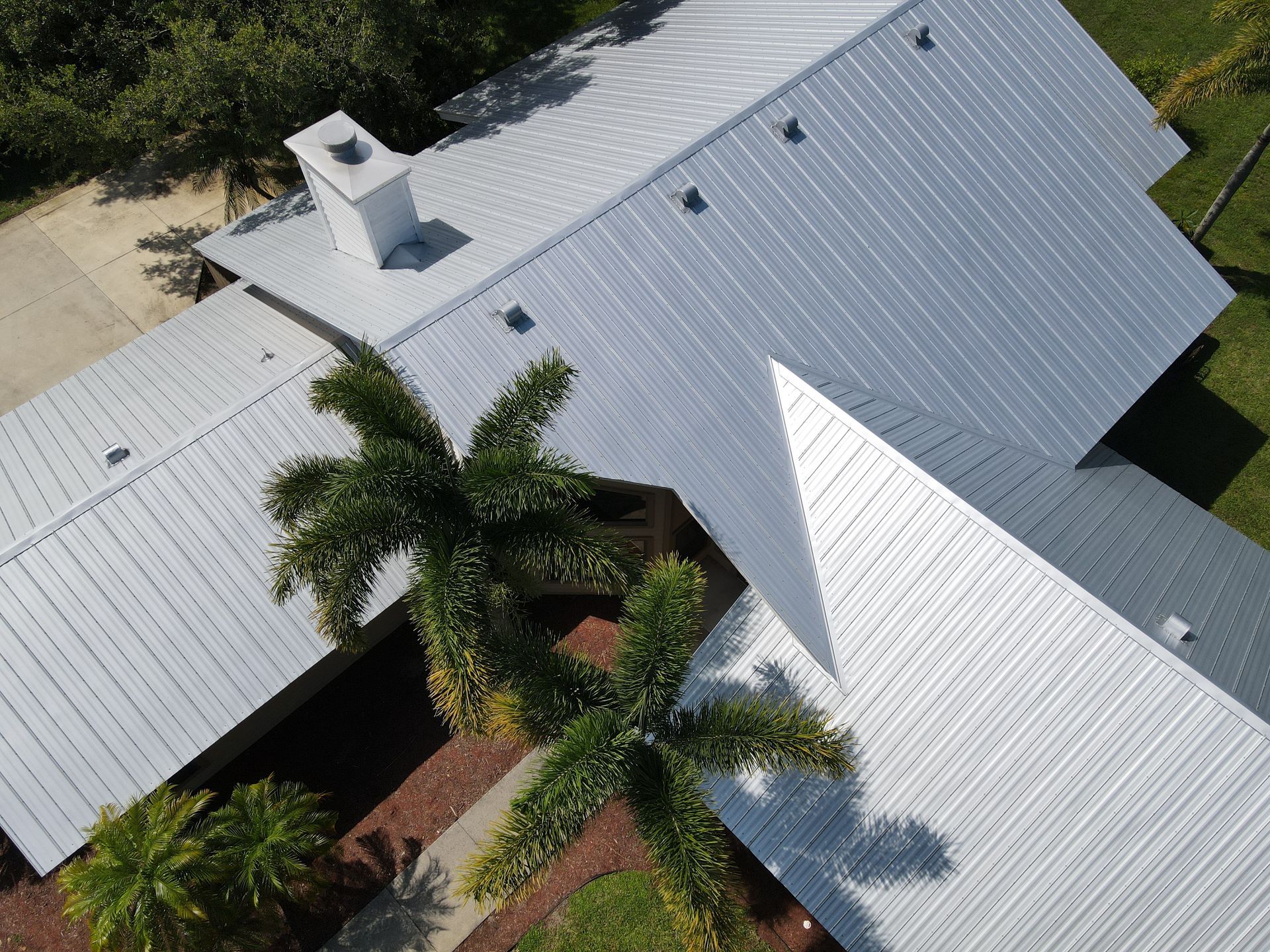 An aerial view of a house with a metal roof