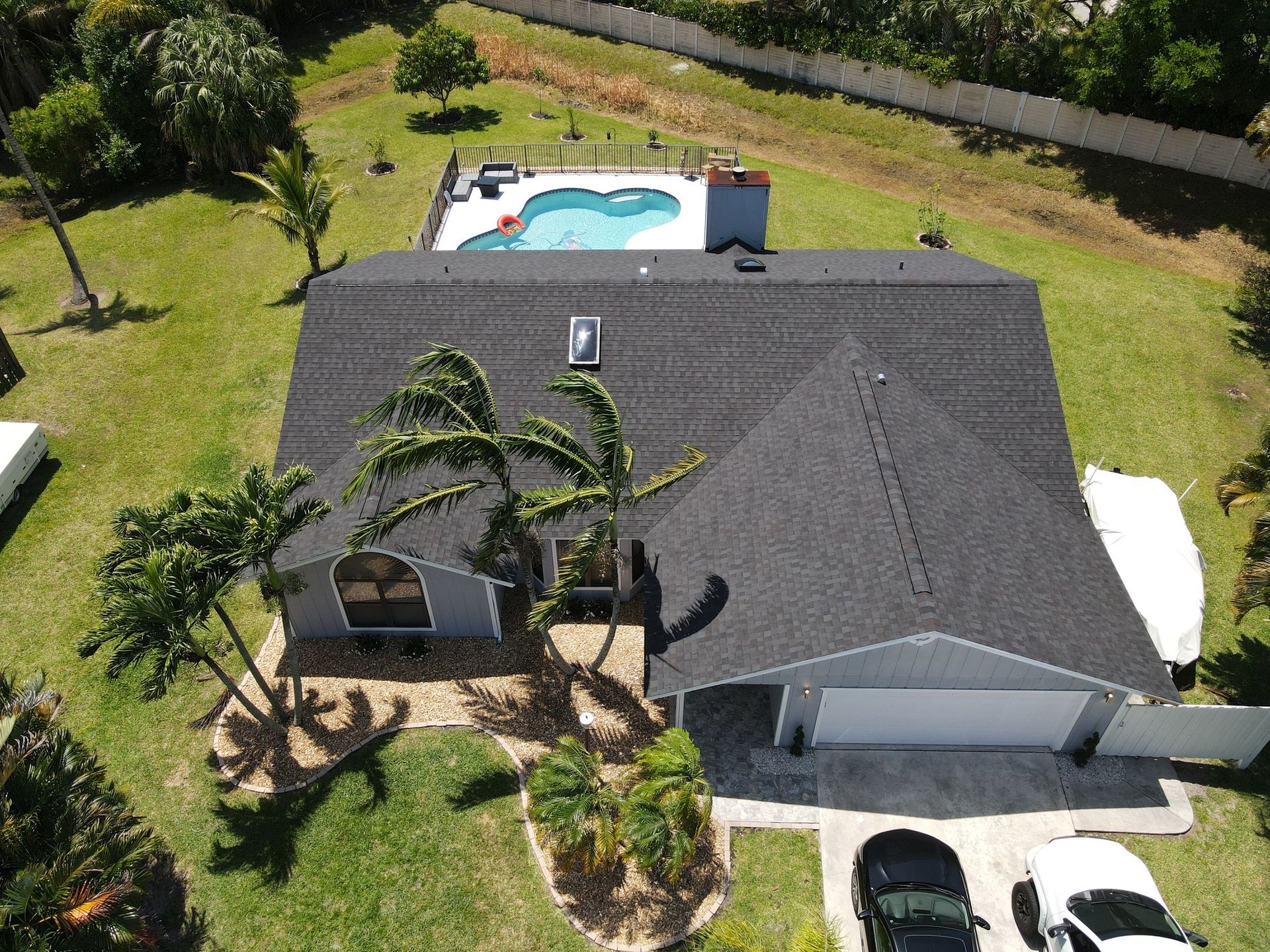 A white chicken coop with a metal roof and shutters