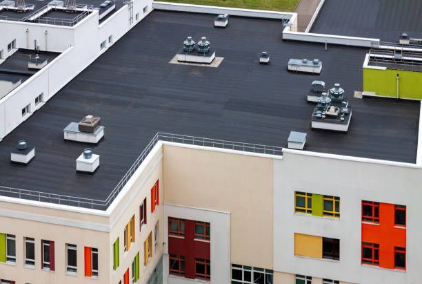 Top view of a commercial building with a dark flat roof