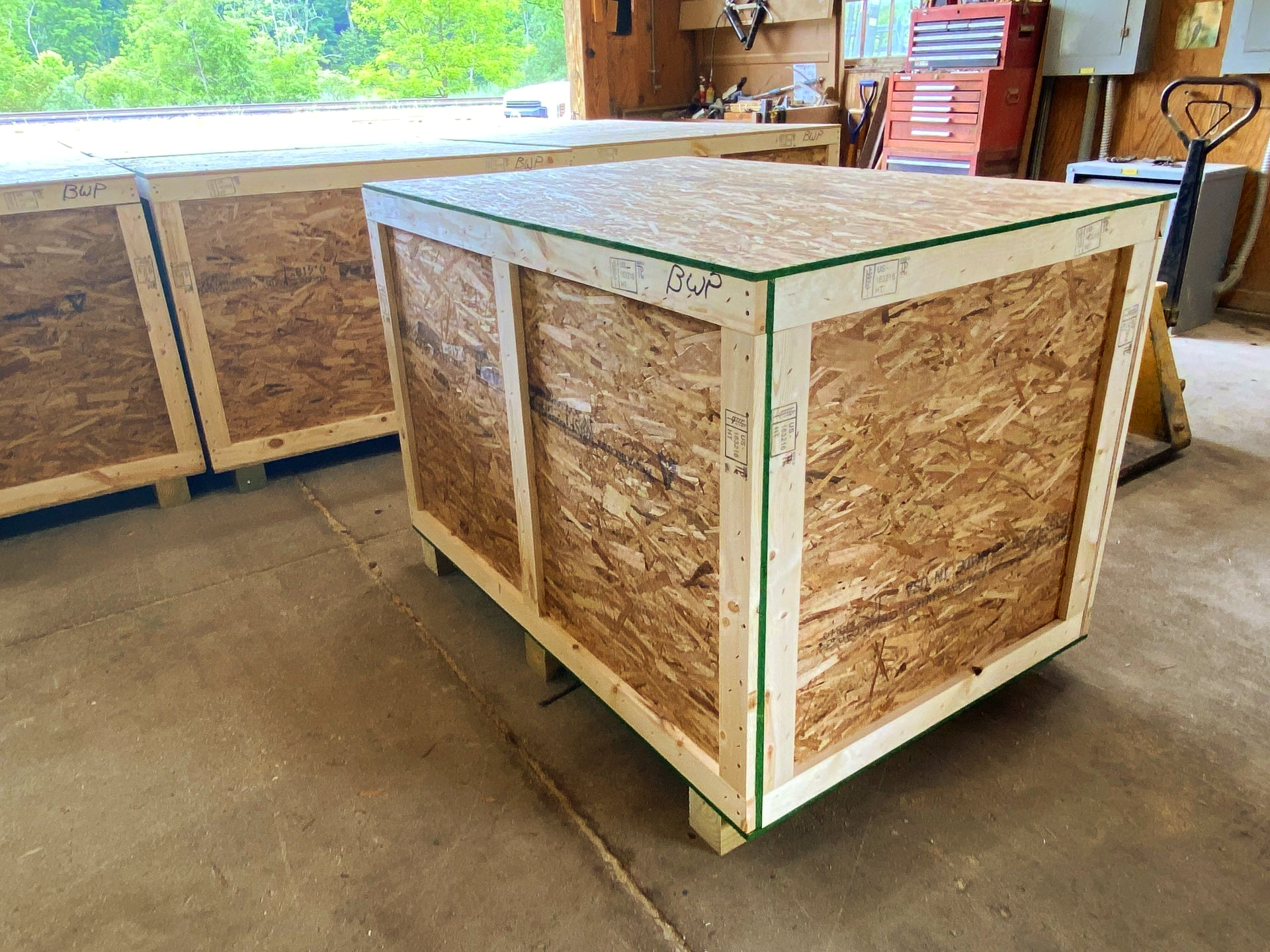 A wooden box is sitting on the floor in a room.