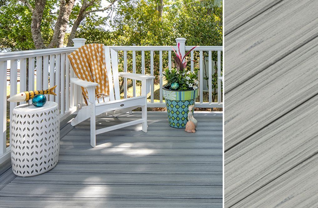 A deck with a chair , table , and potted plants.