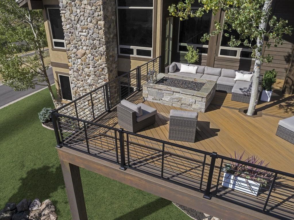 An aerial view of a deck with furniture and a fire pit.