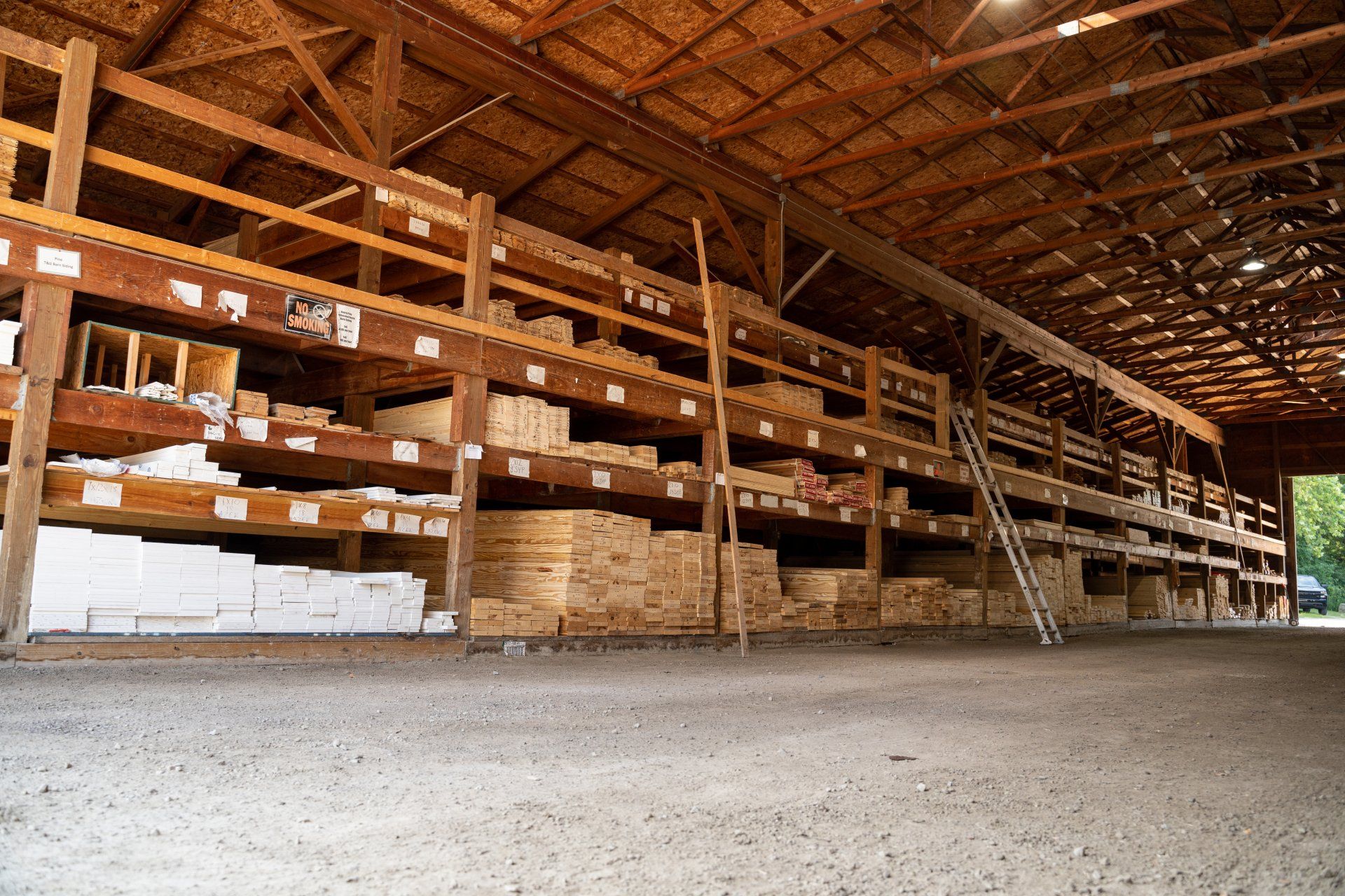 A large warehouse filled with lots of wooden shelves