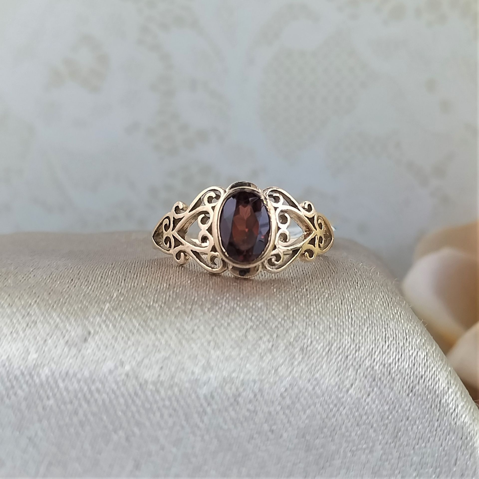 A gold ring with a purple stone in the center