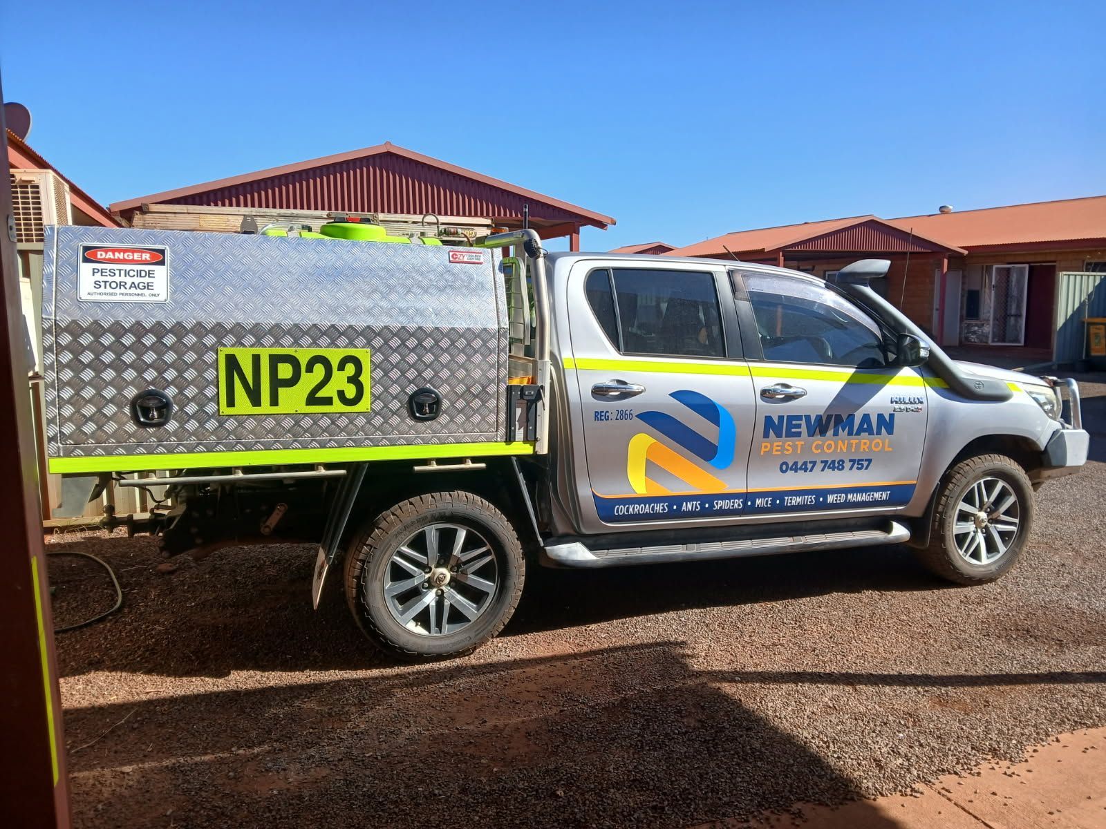 Silver Newman Electrical truck with NP23 plate, parked outdoors.