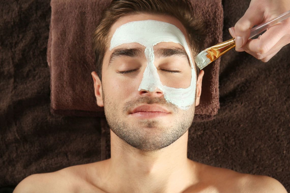 a man is getting a facial treatment at a spa .