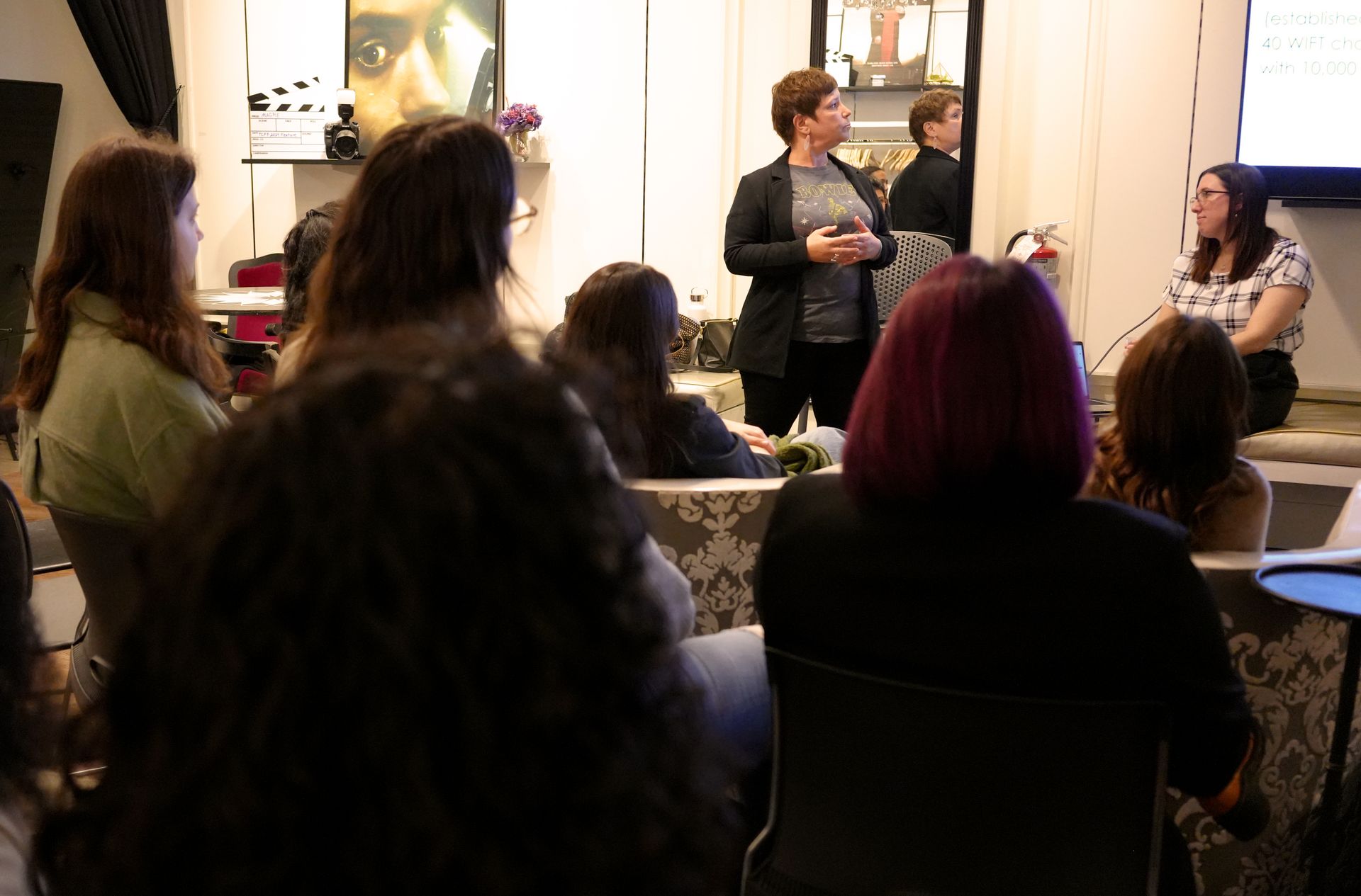 A woman is giving a presentation to a group of people