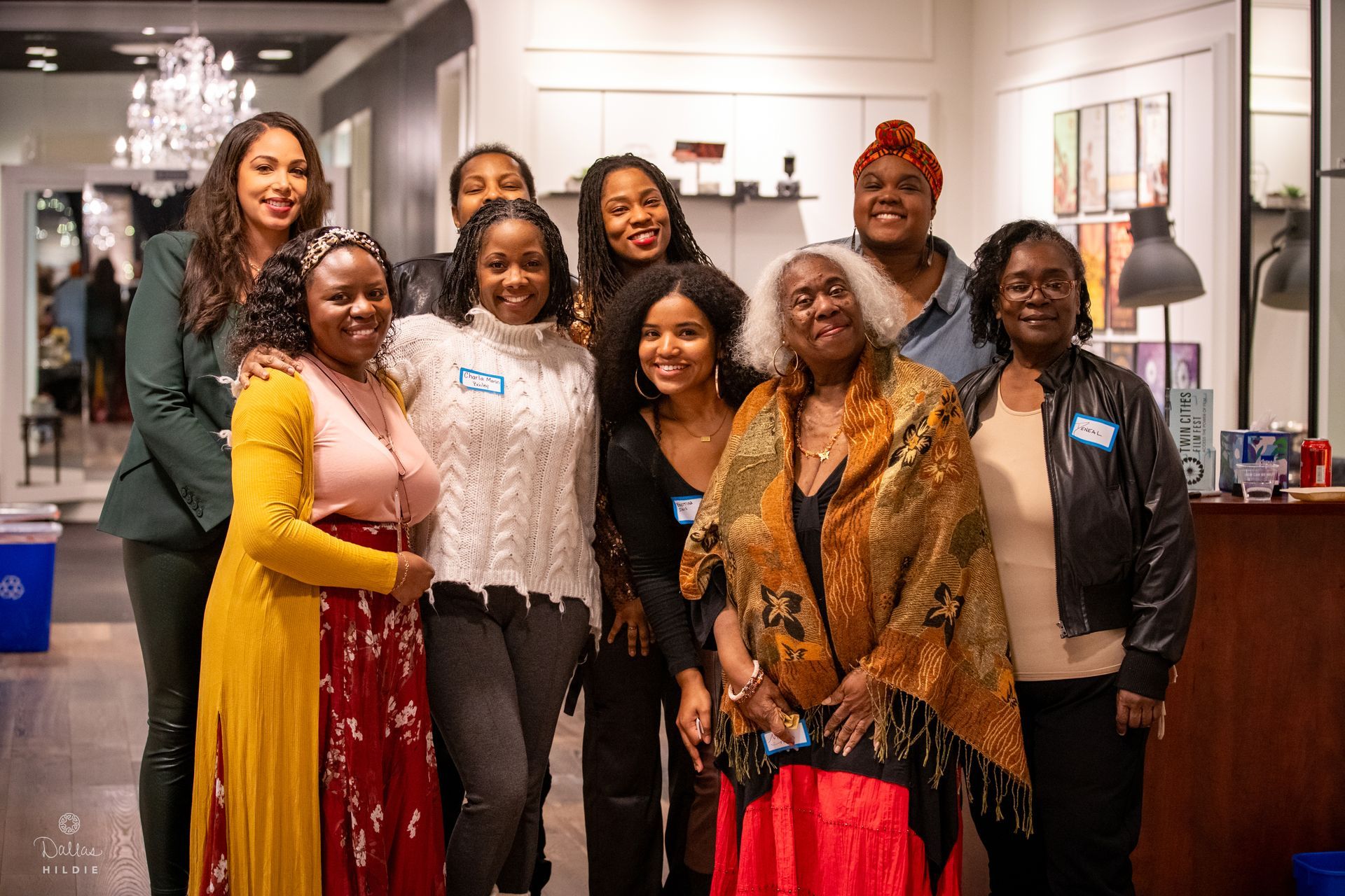 A group of women are posing for a picture together in a room.