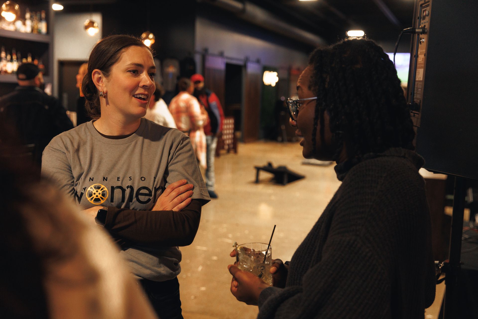 A man and two women are posing for a picture in a restaurant.