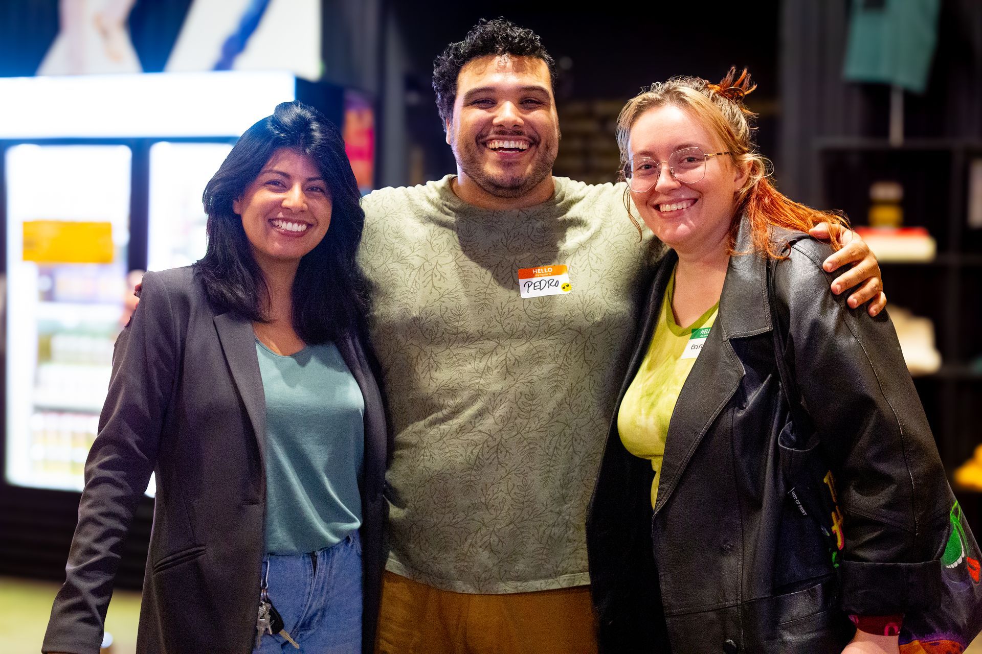 A man and two women are posing for a picture together.