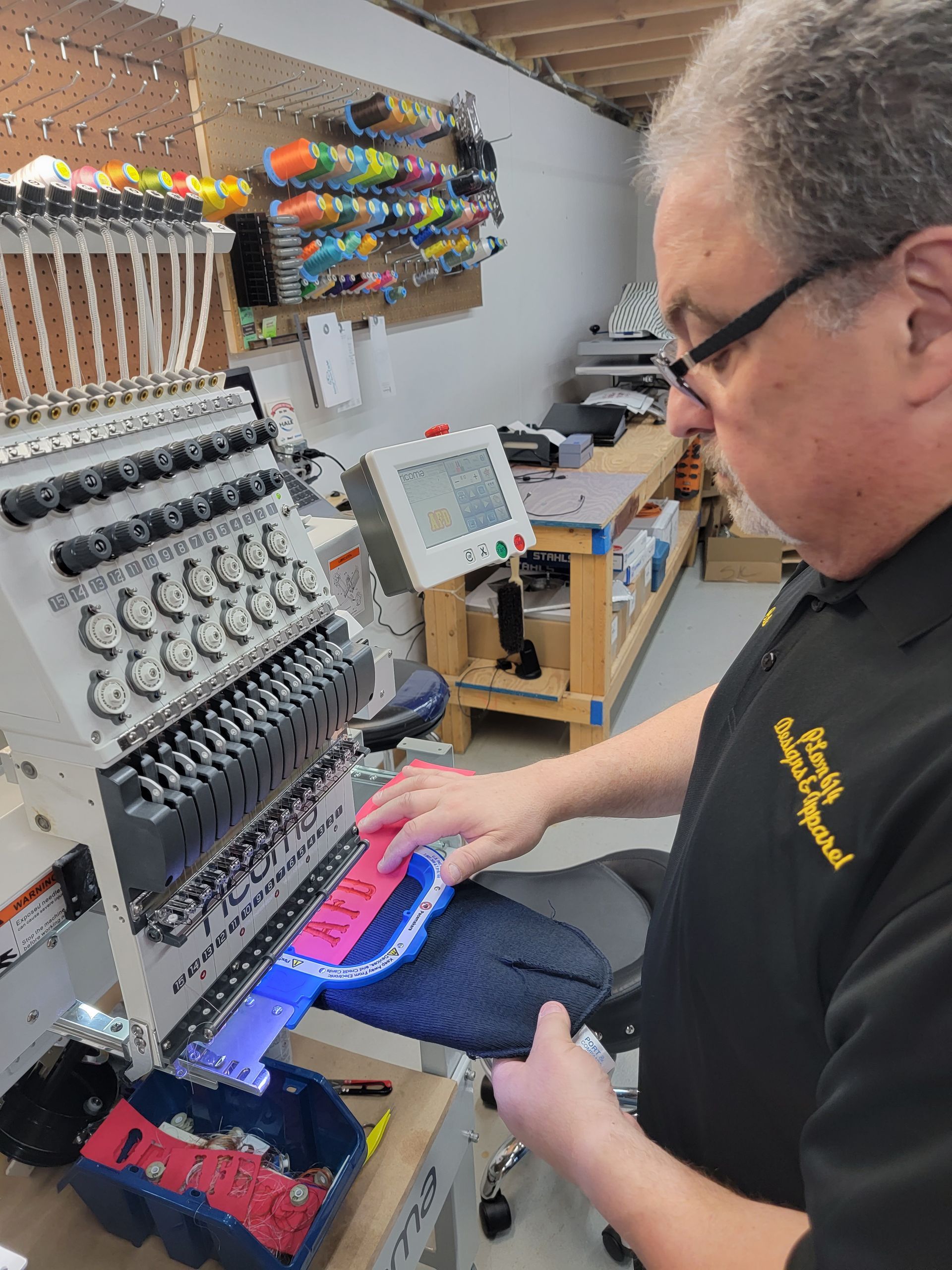 A man in a black shirt is working on a machine.