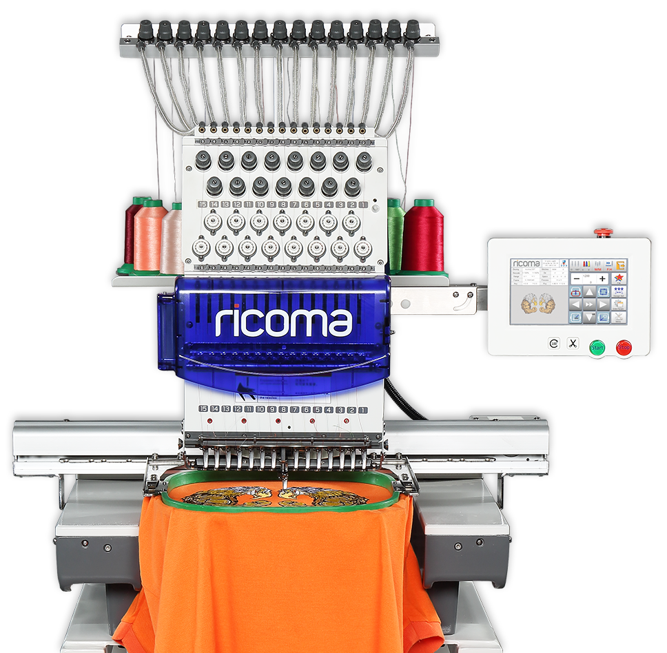 A ricoma embroidery machine is sitting on a table with an orange shirt on it.