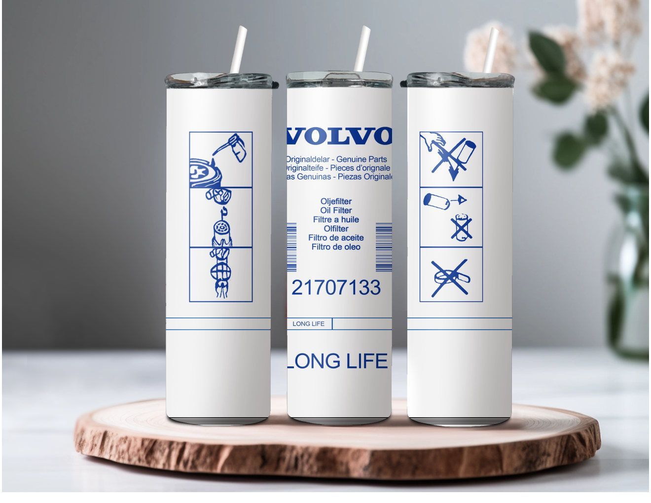 Three volvo stainless steel tumblers are sitting on a wooden tray.