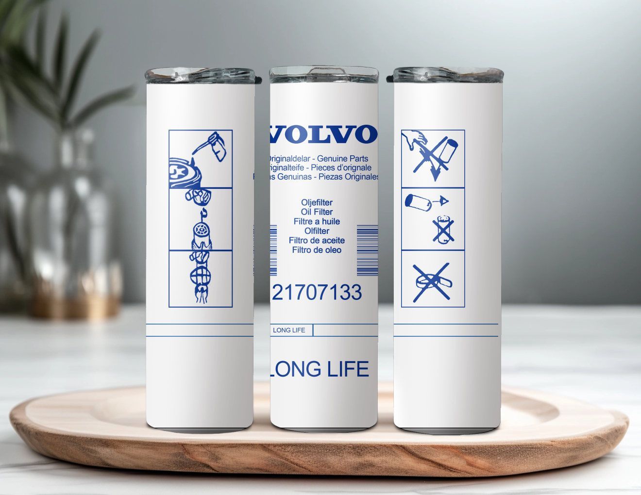 Three volvo stainless steel tumblers are sitting on a wooden tray.