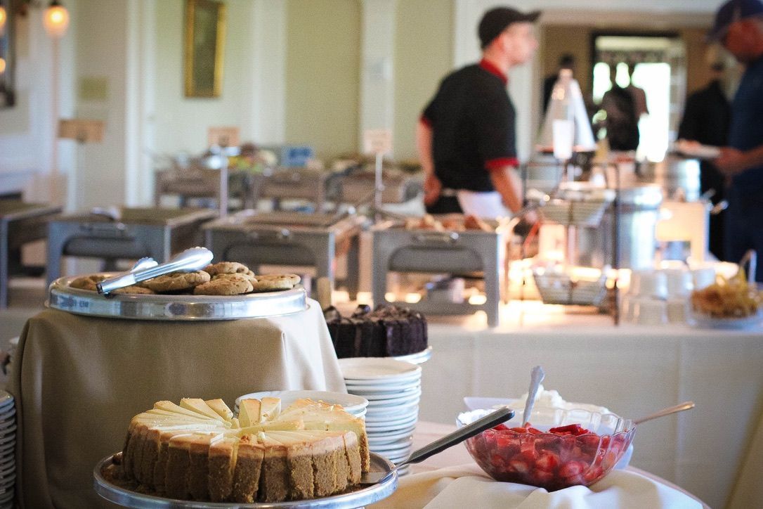 A buffet table with a variety of desserts on it.