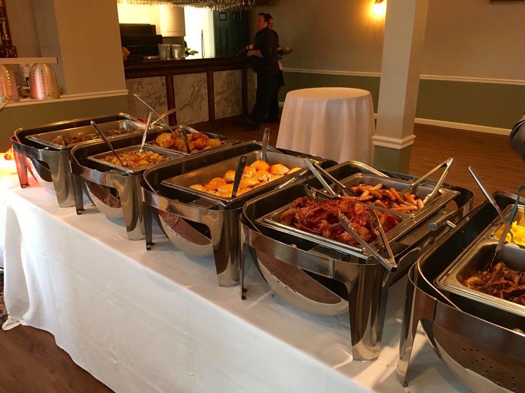 A buffet table with a variety of food on it.