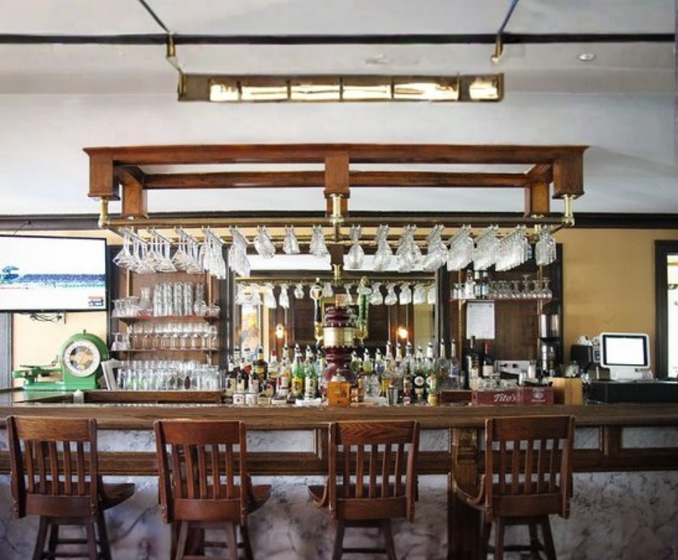 A patio with tables and chairs and umbrellas on a sunny day