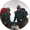 Two people in hiking gear pose outdoors, likely in a cold environment.