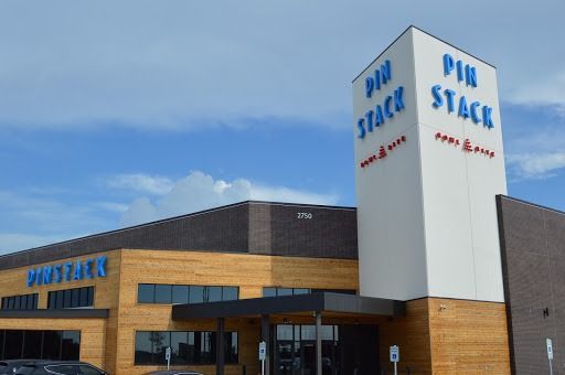 Pin Stack restaurant exterior, blue and white sign on a modern building.