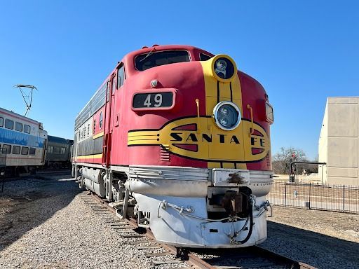 Red and yellow Santa Fe diesel train engine #49 on tracks.
