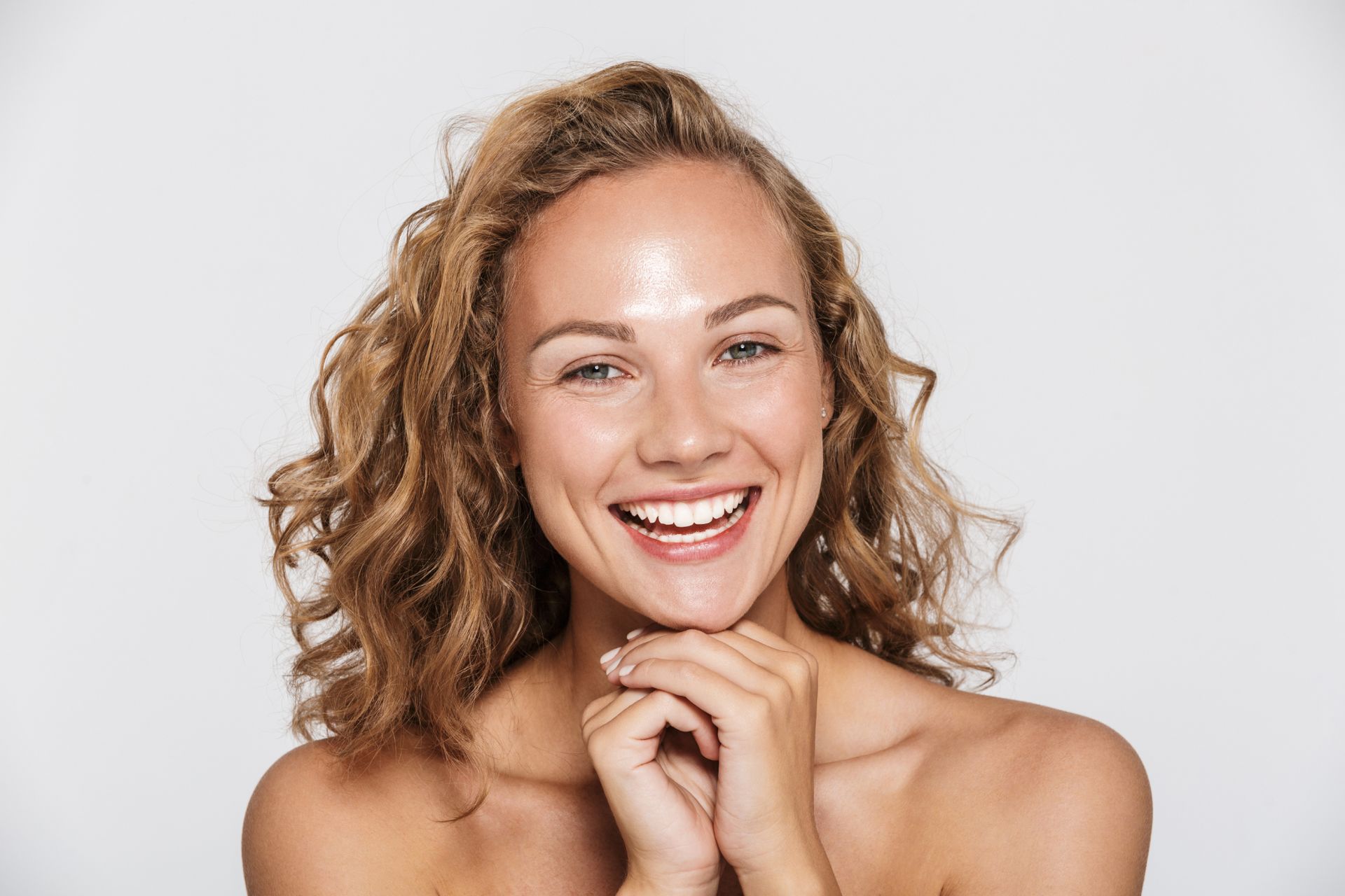smiling young white woman with shiny hydrated skin