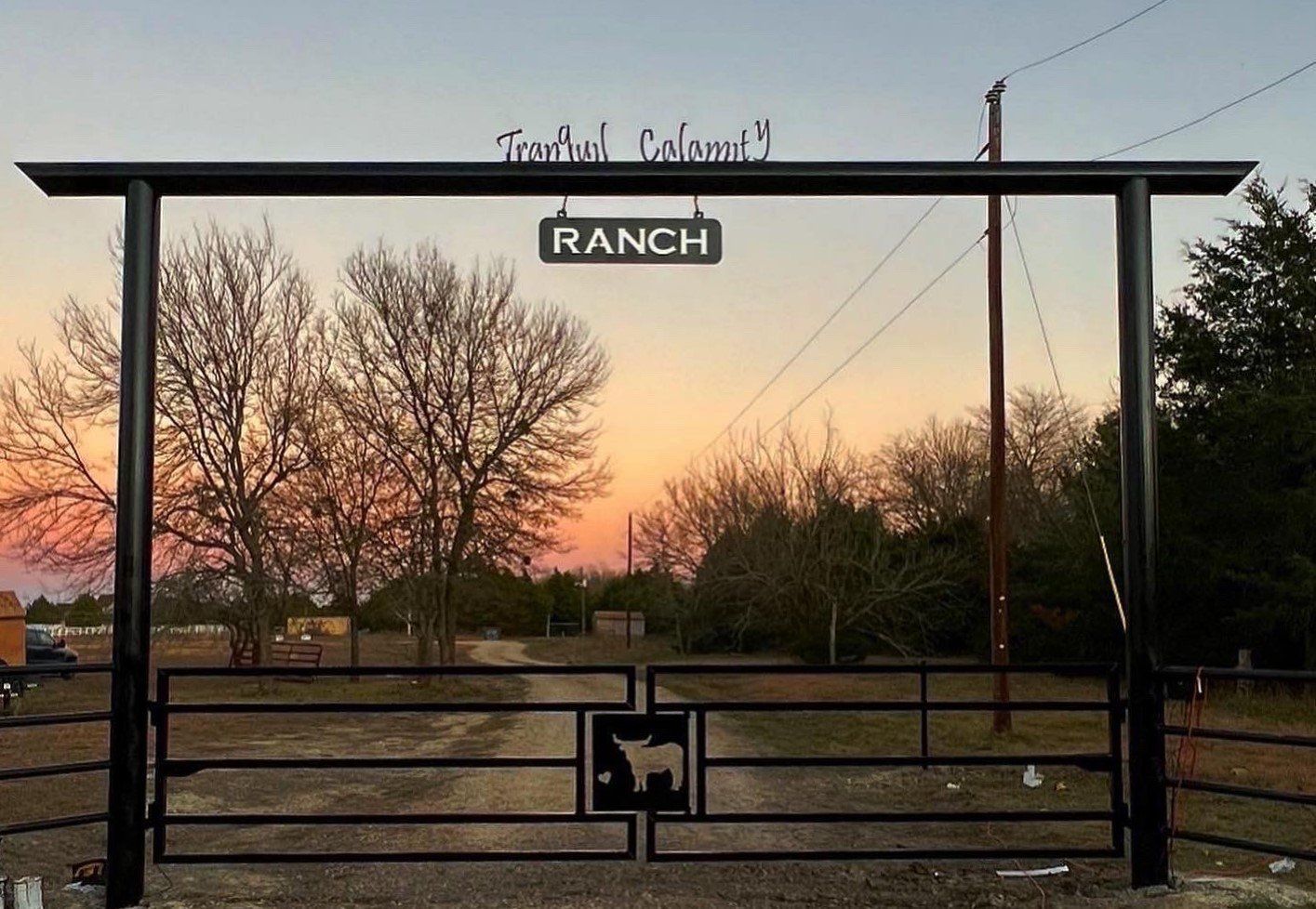 A gate with a sign that says ranch on it