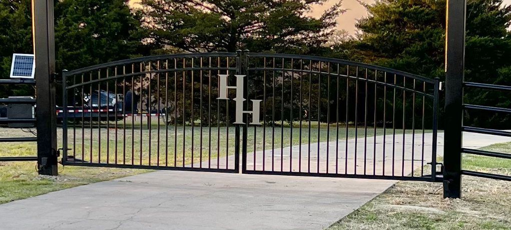 A black metal gate with the letter h on it