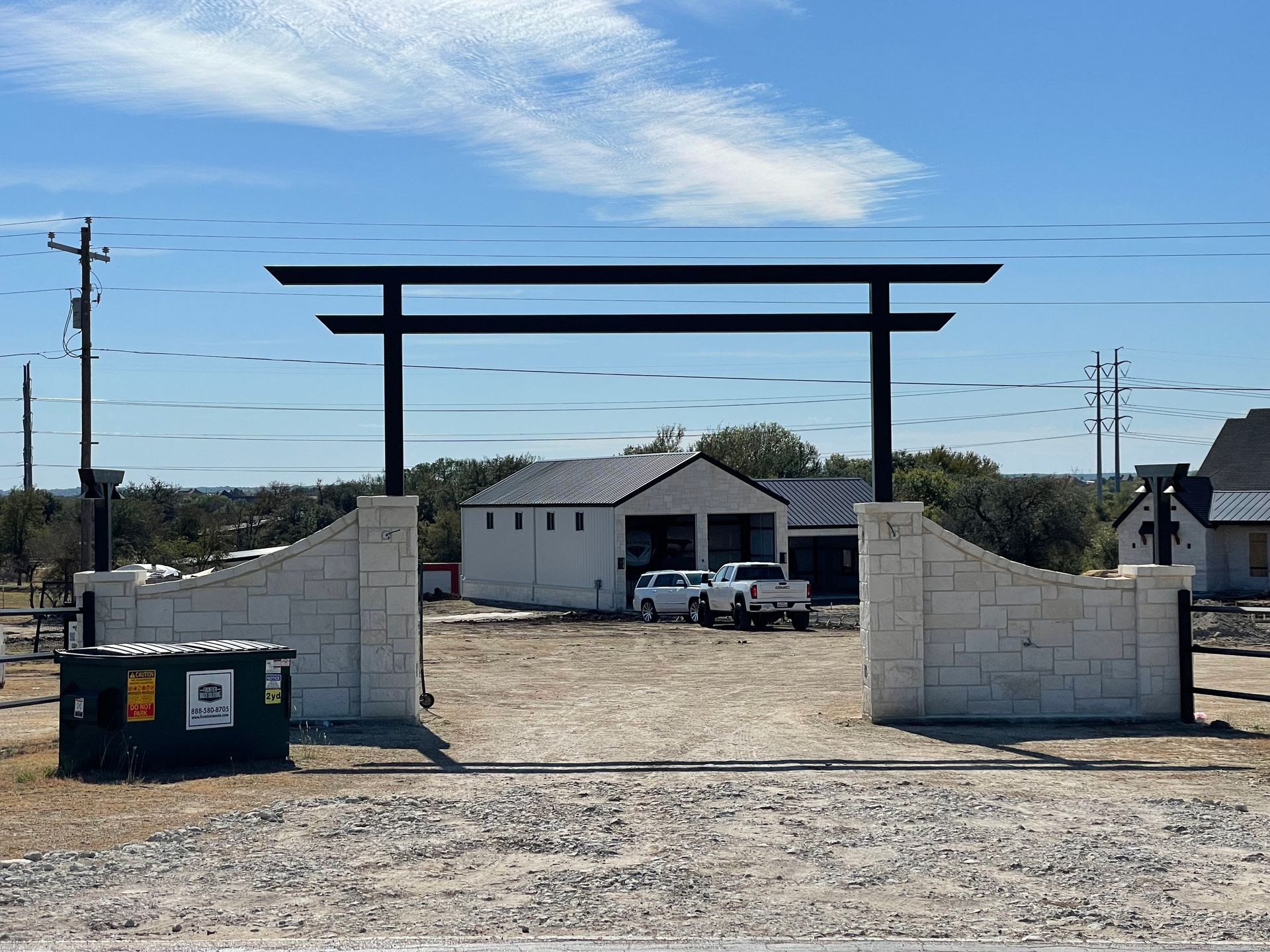 A white house with a black torii gate in front of it