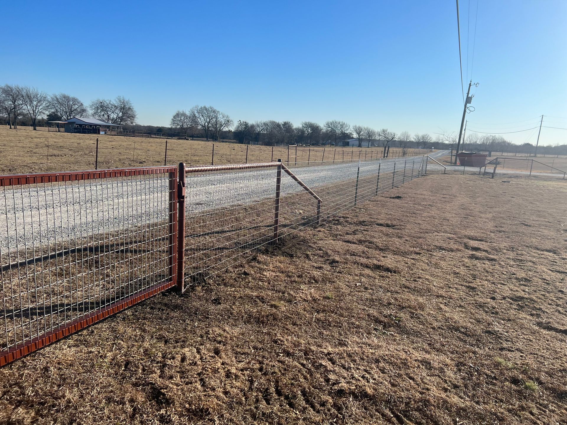 There is a fence in the middle of a field.