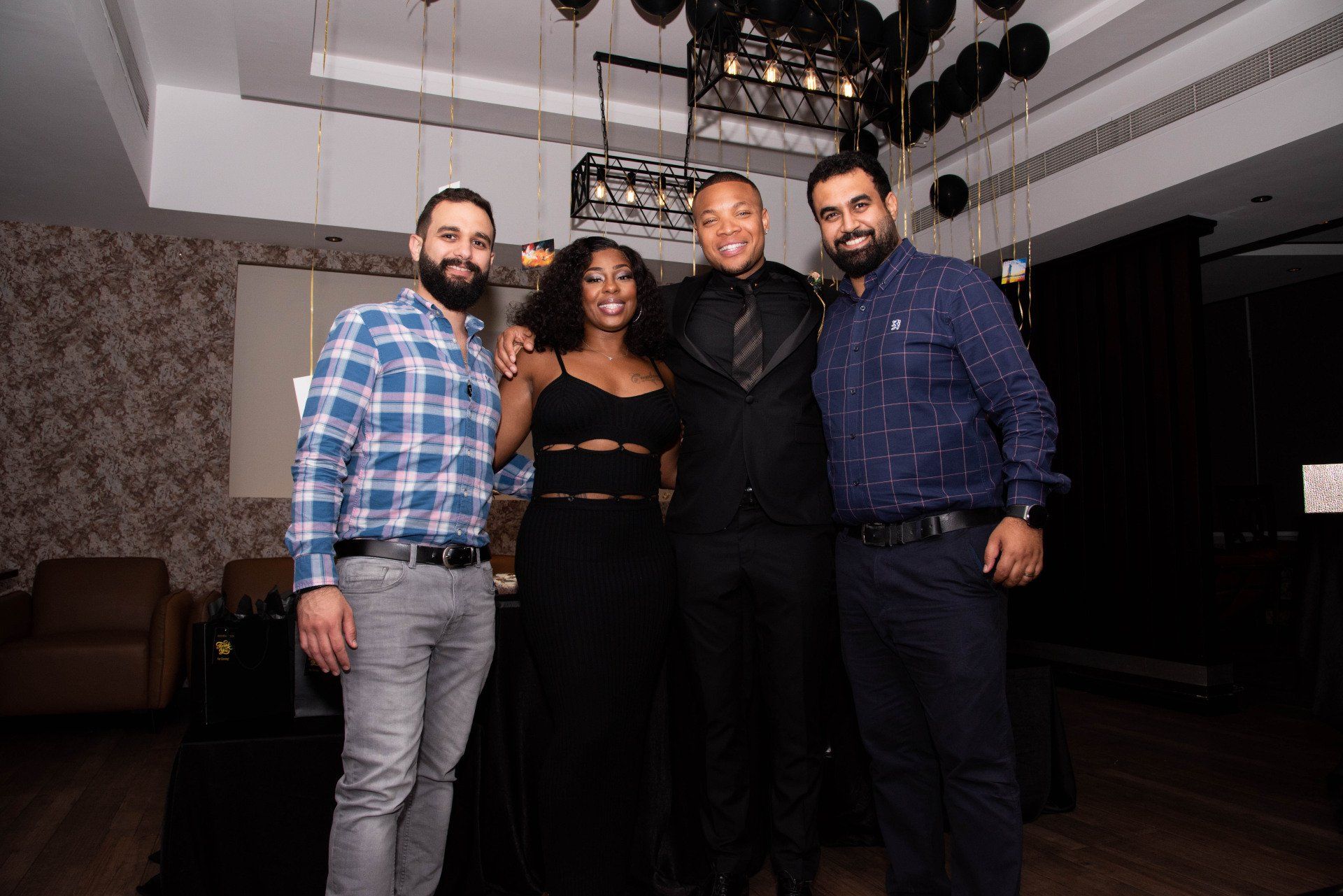 Stephanie LaPierre (CEO) and 3 gentlemen at a party