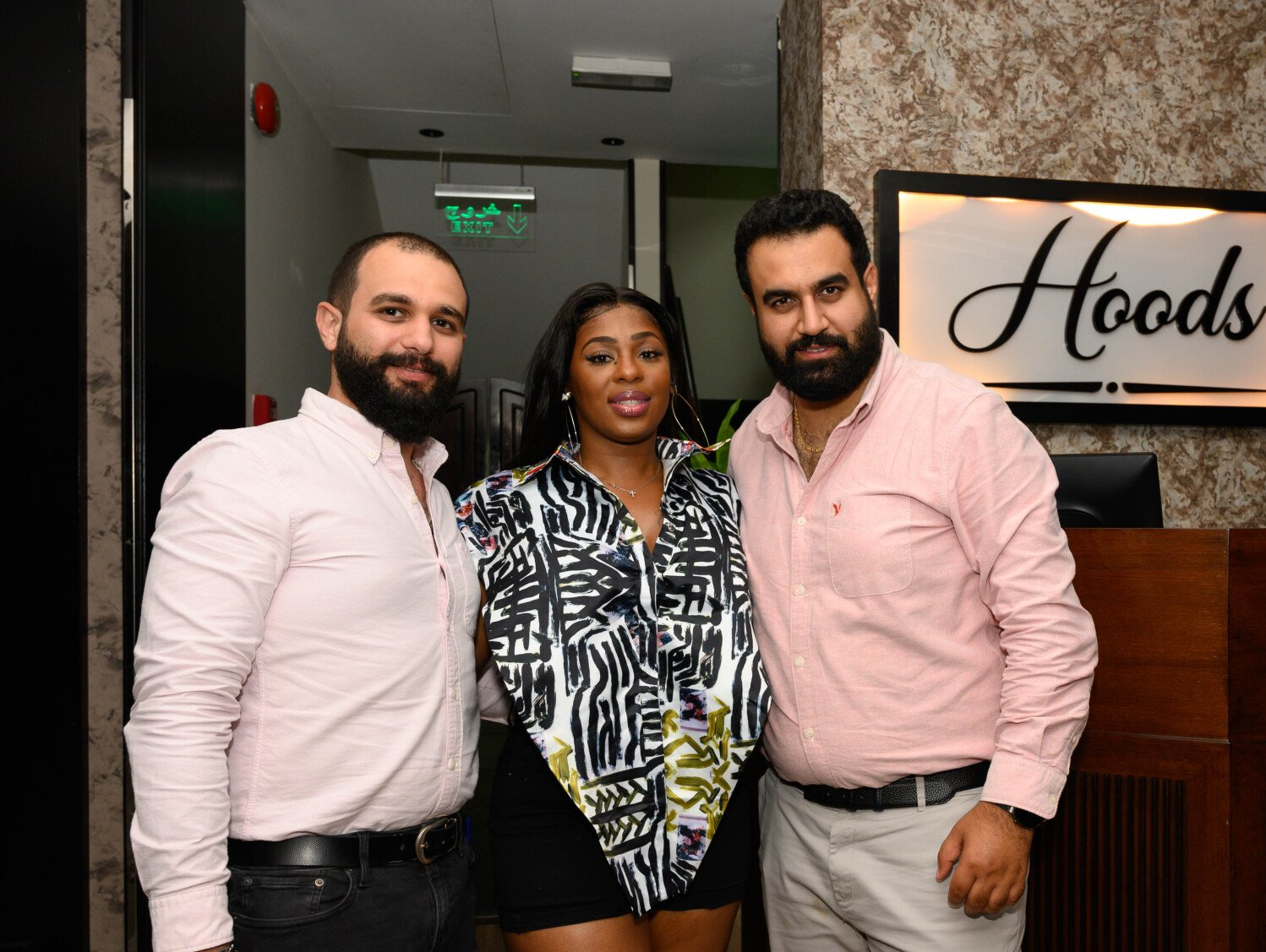 Stephanie LaPierre (CEO) and 2 men standing inside Hoods Restaurant
