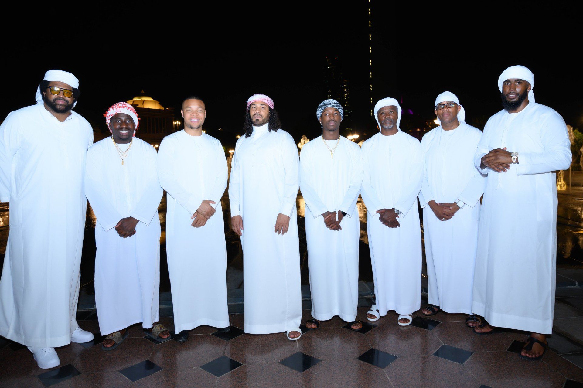 Approximately 7 men standing on white robes