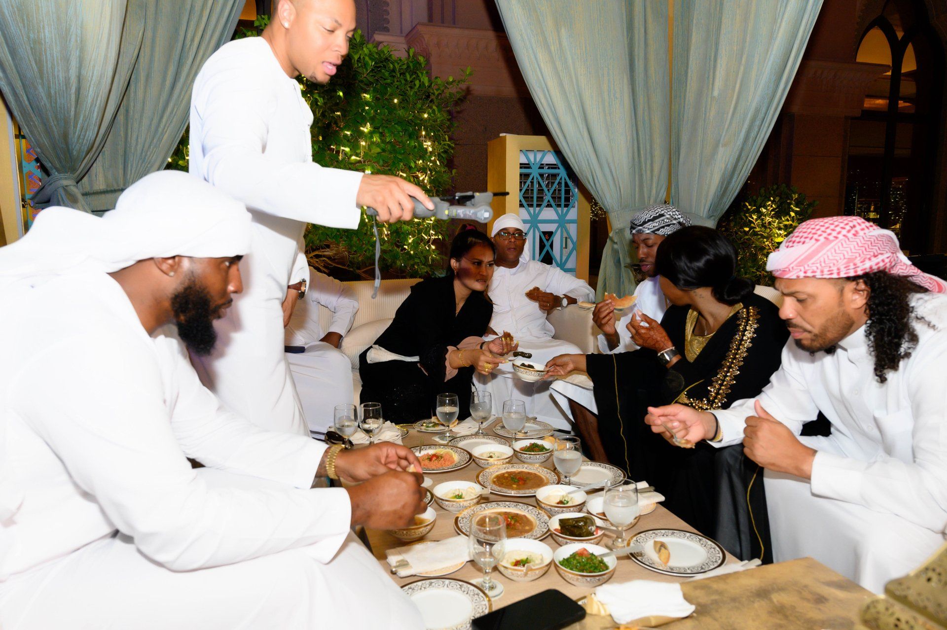 Stephanie LaPierre (CEO) and several others being served a catered dinner