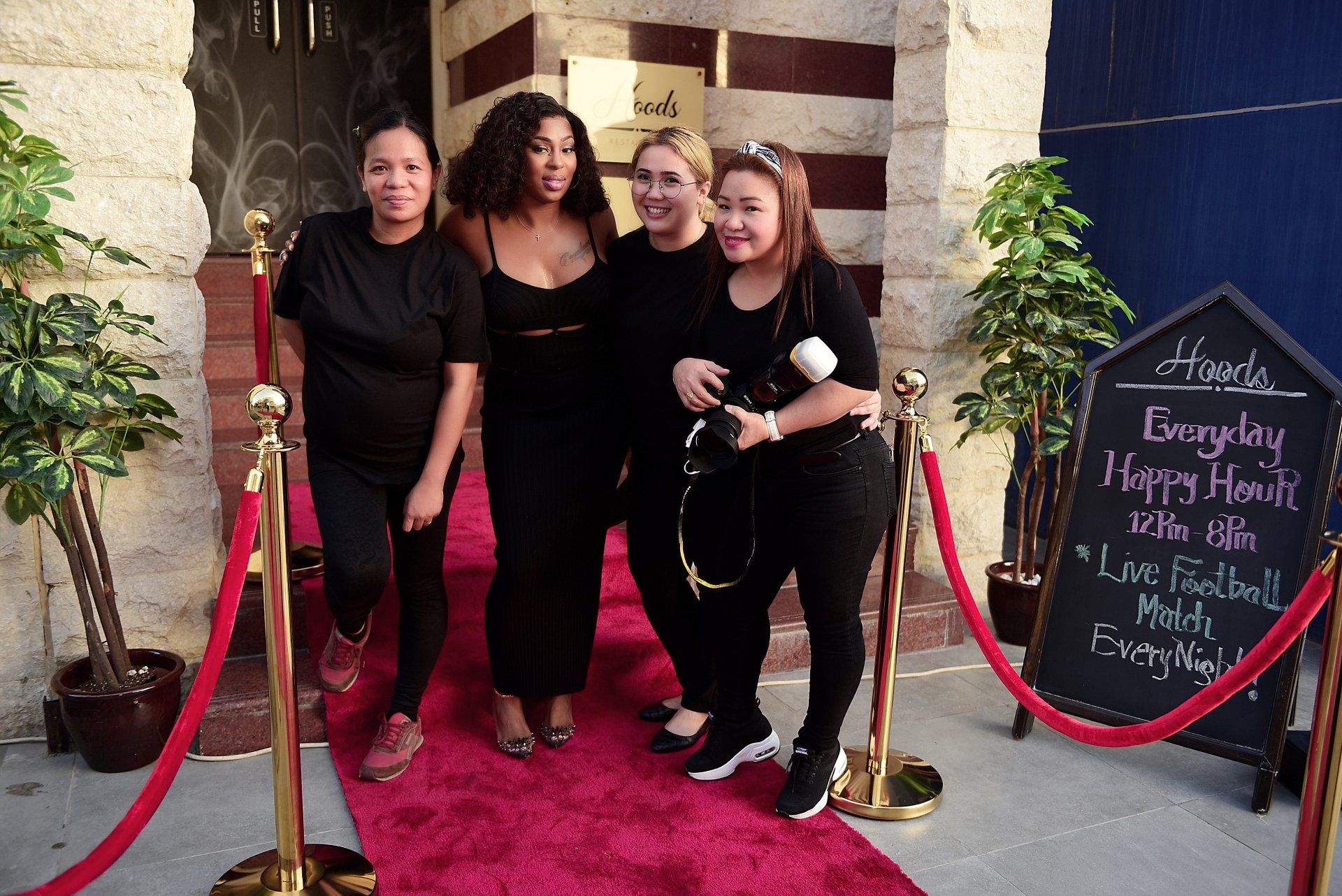 Stephanie LaPierre (CEO) and 3 DEPS staff members standing on a red carpet in front of Hoods Restaurant
