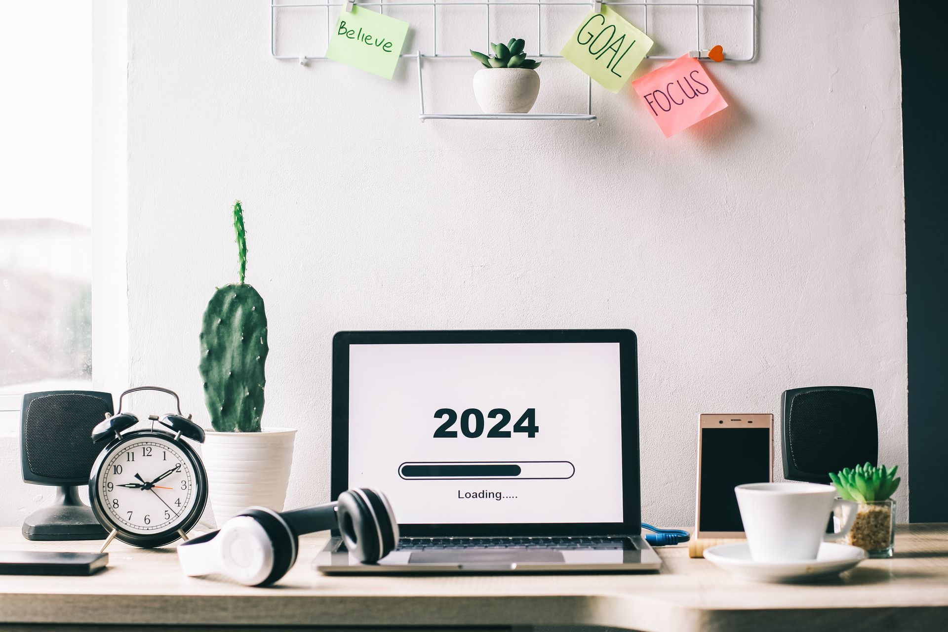 A work space displaying a desk, computer and the current year.