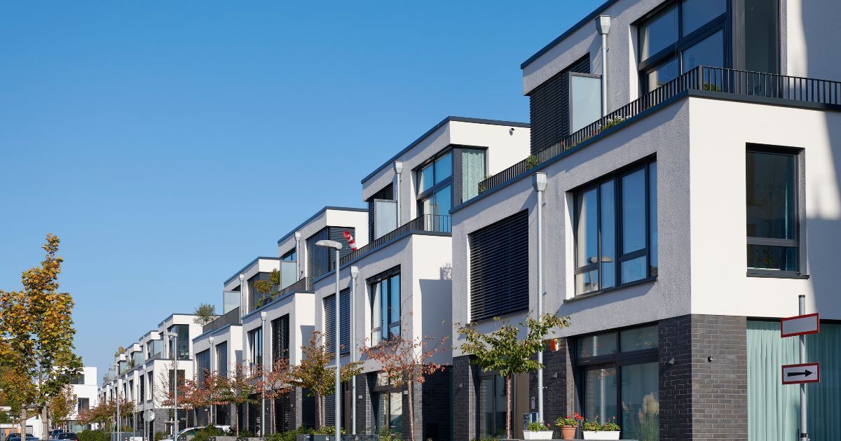 A row of buildings with lots of windows on a sunny day.