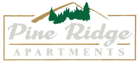 The pine ridge apartments logo has a mountain and trees on it.