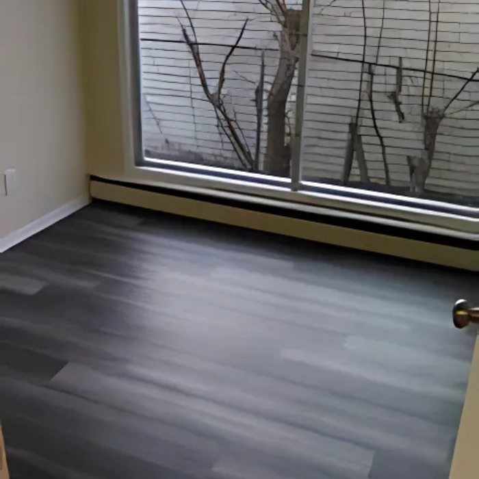 An empty room with a sliding glass door and a window.