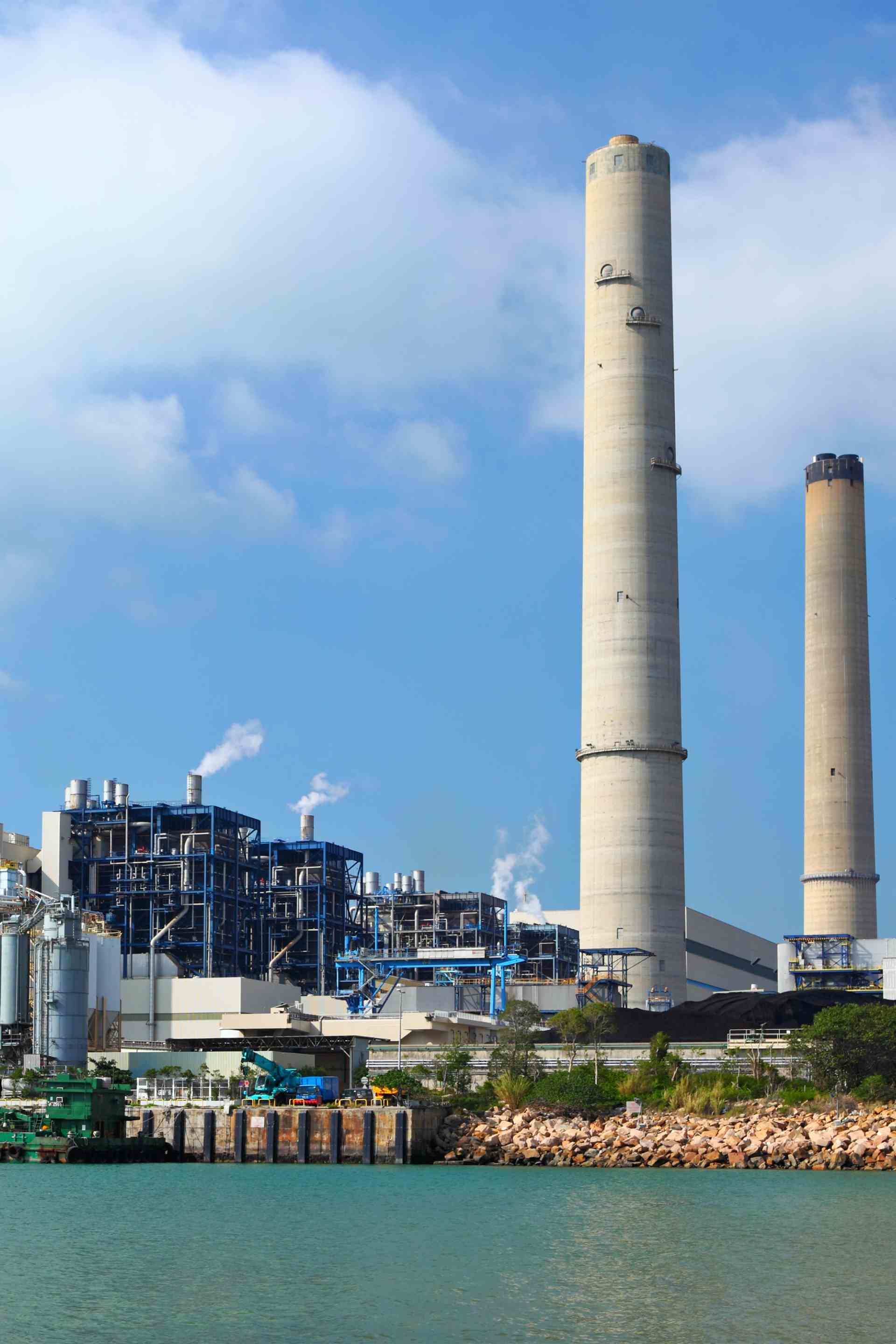 A factory with a lot of smoke coming out of the chimneys