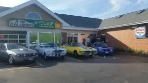 Some Americans' Muscles Parked in Front of Auto Evaluators in St. Louis, MO