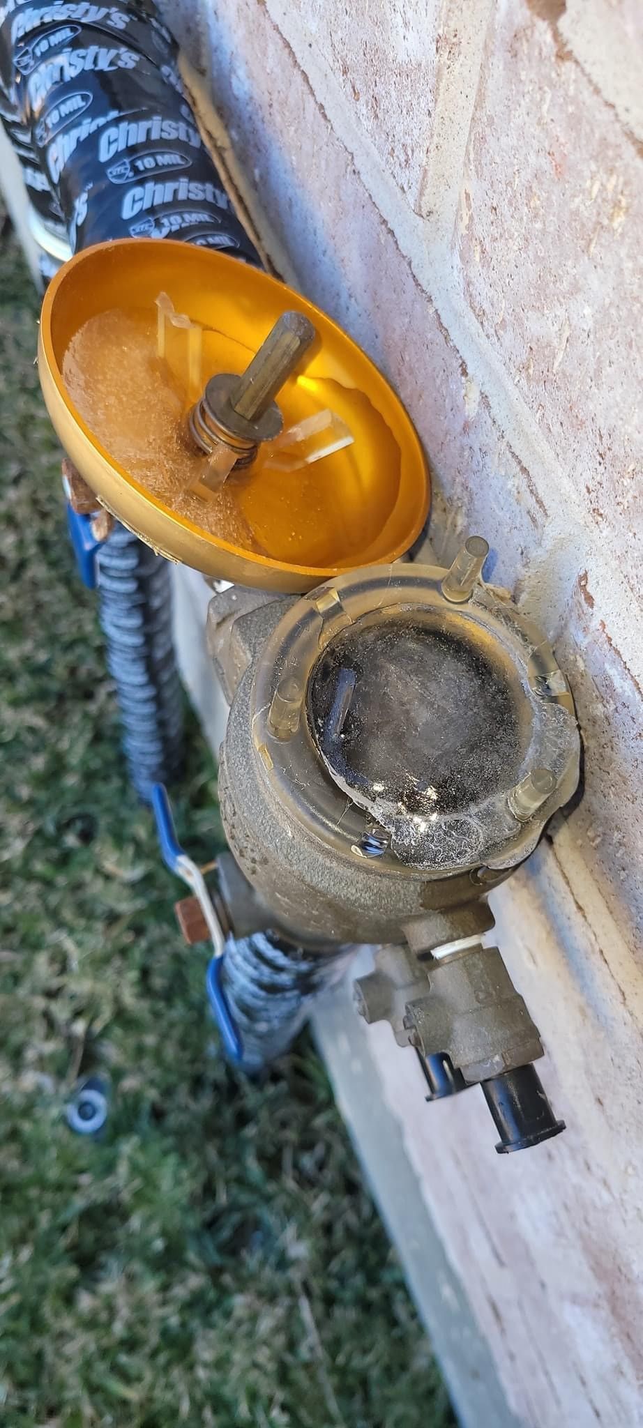 A close up of a water meter with a yellow cap on it.