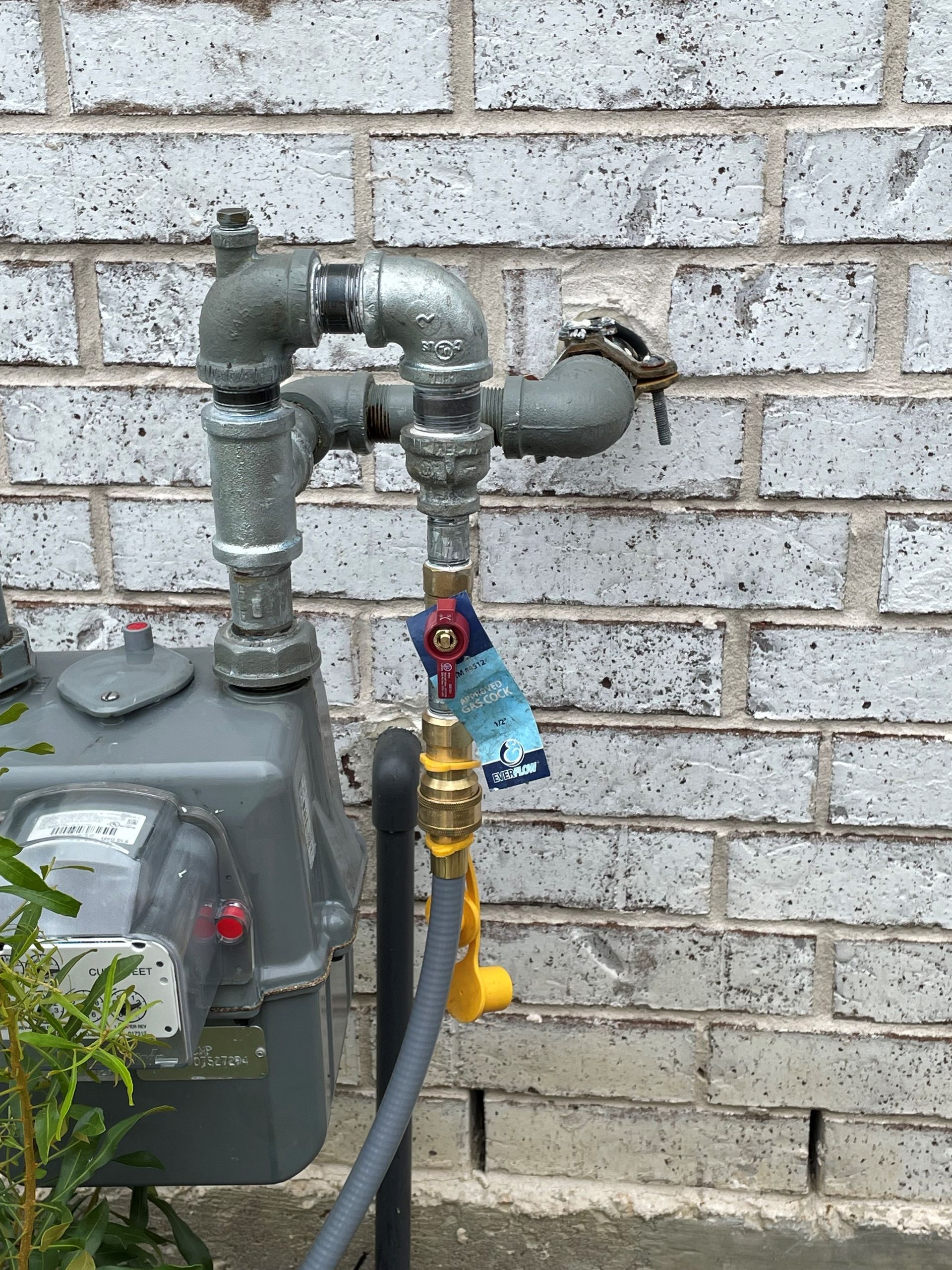 A gas meter with a hose attached to it