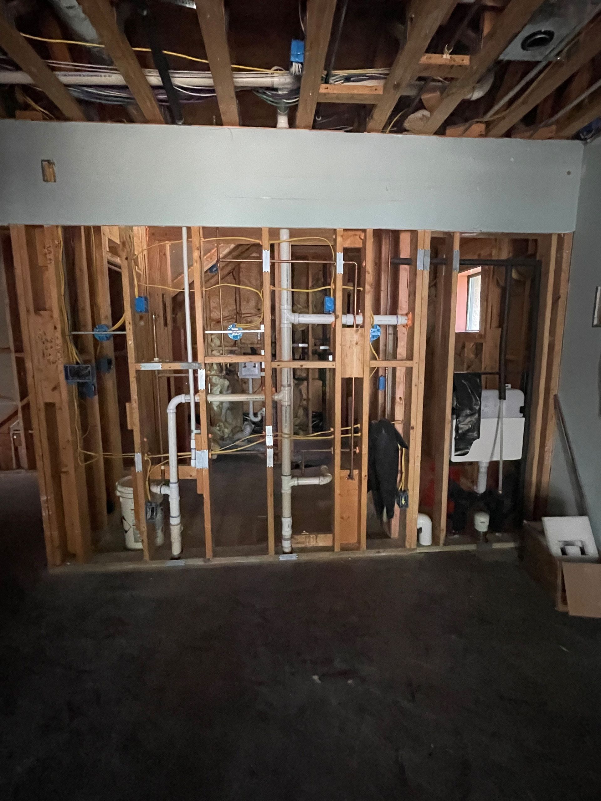 A room that is being built with a lot of pipes in it