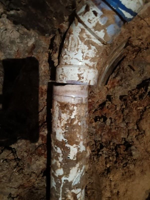 A close up of a dirty pipe in the dirt