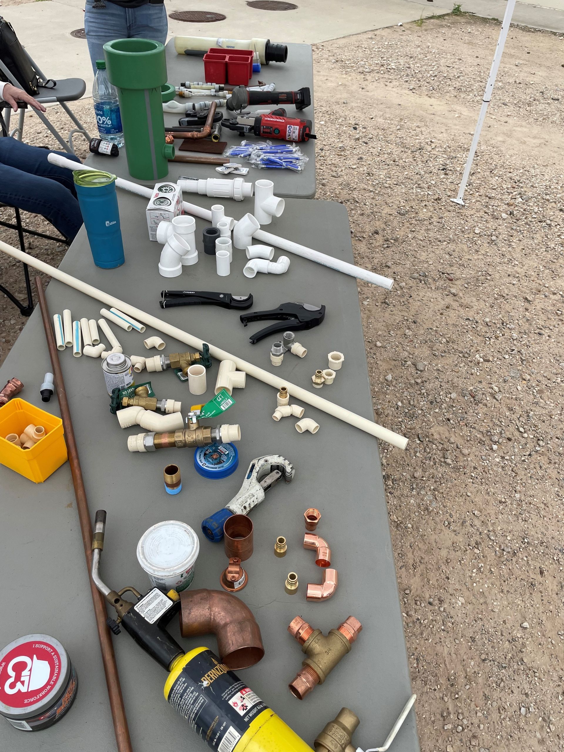 A table with a lot of pipes and tools on it