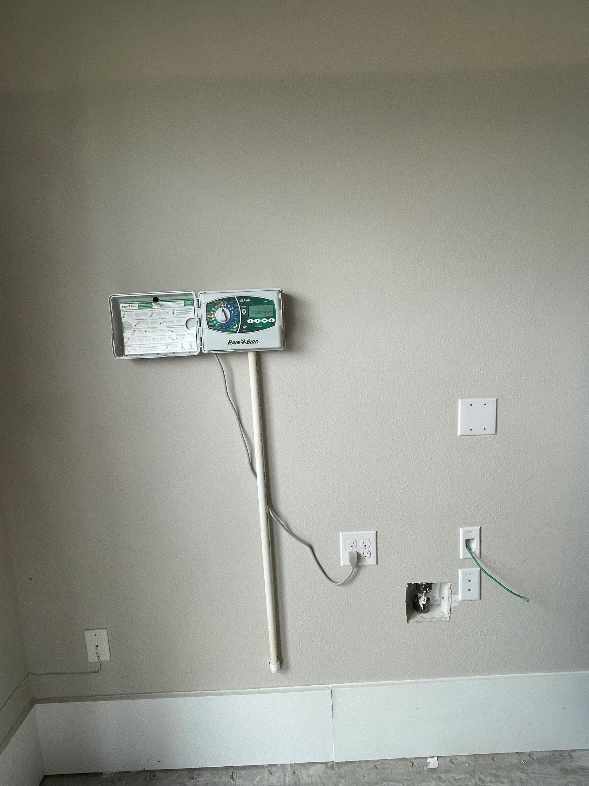 A mop is hanging on a wall in a room.